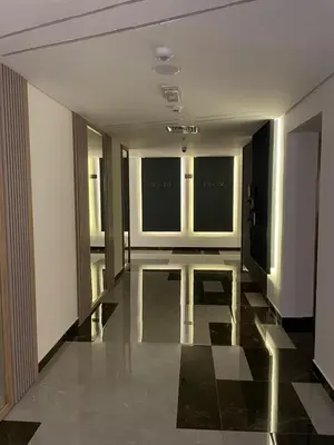 a room with a hallway with windows and a shiny floor at A place like home in Dubai