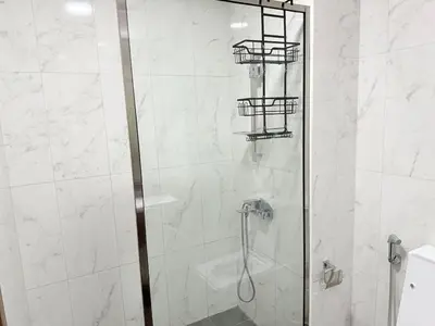 a shower with a glass door in a bathroom at A place like home in Dubai