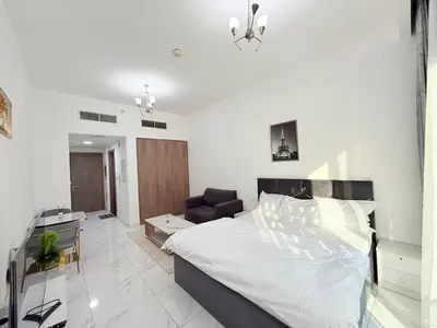 a bedroom with a bed and a living room at A place like home in Dubai