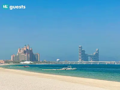 a view of a beach with a city in the background at HiGuests - Oceanfront Luxurious 3BR at Th8 Palm Dubai in Dubai
