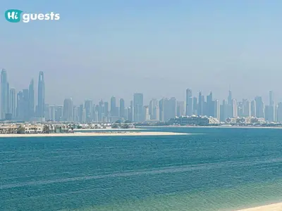 a view of a city from the beach with the ocean at HiGuests - Oceanfront Luxurious 3BR at Th8 Palm Dubai in Dubai