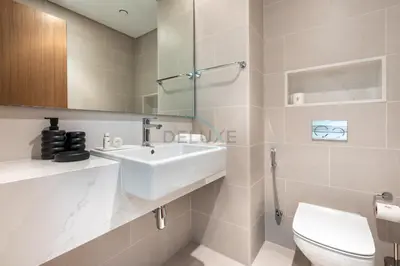 a bathroom with a white sink and a toilet at Spacious 3BR Living, Walking Distance to Dubai Water Canal and Park, Near Safa Park Marine Transport Station, Canal Front 9B, Al Wasl by Deluxe Holiday Homes in Dubai