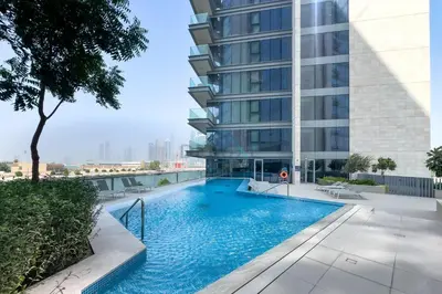 a swimming pool on the side of a building at Spacious 3BR Living, Walking Distance to Dubai Water Canal and Park, Near Safa Park Marine Transport Station, Canal Front 9B, Al Wasl by Deluxe Holiday Homes in Dubai