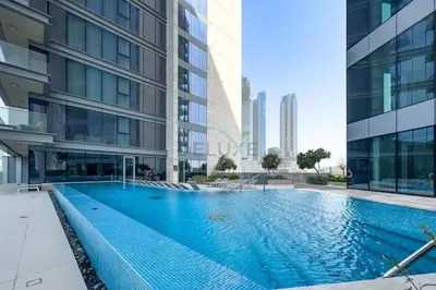 a swimming pool in the middle of a building at Spacious 3BR Living, Walking Distance to Dubai Water Canal and Park, Near Safa Park Marine Transport Station, Canal Front 9B, Al Wasl by Deluxe Holiday Homes in Dubai