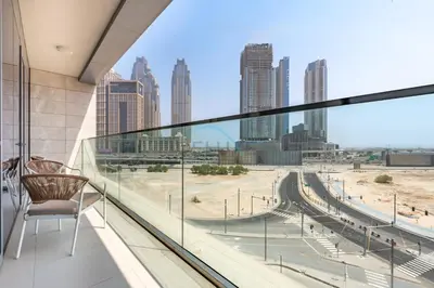 a chair on a balcony with a view of a city at Spacious 3BR Living, Walking Distance to Dubai Water Canal and Park, Near Safa Park Marine Transport Station, Canal Front 9B, Al Wasl by Deluxe Holiday Homes in Dubai
