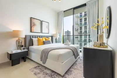 a bedroom with a large bed and a large window at Modern 2BR with Private Pool, Near Circle Mall And Quick Access from Al Khail Road, Binghatti Tulip, JVC by Deluxe Holiday Homes in Dubai