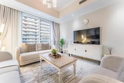 a living room with white furniture and a flat screen tv at Walking distance to Dubai Mall and Burj Khalifa, Easy access to Dubai Metro and Top attractions, Dunya Tower, Downtown Dubai by Deluxe Holiday Homes in Dubai