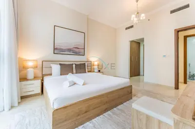 a bedroom with a large bed and a table at Walking distance to Dubai Mall and Burj Khalifa, Easy access to Dubai Metro and Top attractions, Dunya Tower, Downtown Dubai by Deluxe Holiday Homes in Dubai