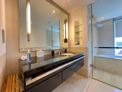 a bathroom with a sink and a mirror and a tub at JW Marriott Marina Residences in Dubai