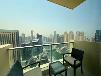 a balcony with two chairs and a view of the city at JW Marriott Marina Residences in Dubai