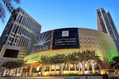 a building in a city with palm trees in front of it at JW Marriott Marina Residences in Dubai