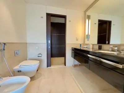 a bathroom with a toilet and two sinks at JW Marriott Marina Residences in Dubai