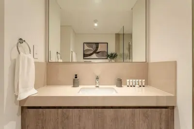 a bathroom with a sink and a mirror at 4BR Gem in Downtown with Full Burj Khalifa View and Dubai Mall Access in Dubai