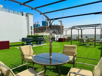 a patio with a table and chairs on a roof at Royalton - Private Pool Luxe Studio in Dubai in Dubai