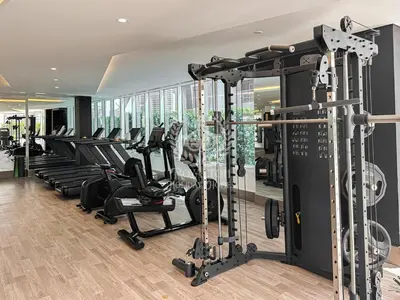 a gym with rows of treadmills and elliptical machines at Royalton - Private Pool Luxe Studio in Dubai in Dubai