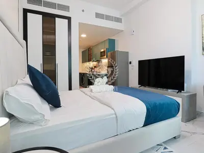 a bedroom with a large bed and a flat screen tv at Royalton - Private Pool Luxe Studio in Dubai in Dubai