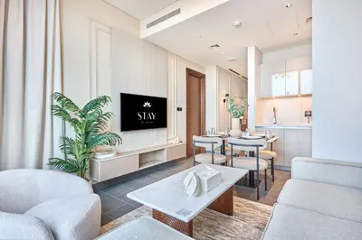 a living room with furniture and a tv on a wall at STAY BY LATINEM Luxury 1BR Holiday Home CB 1210 Near Burj Khalifa in Dubai