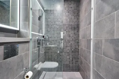 a bathroom with a shower with a glass door at STAY BY LATINEM Luxury 1BR Holiday Home CB 1210 Near Burj Khalifa in Dubai