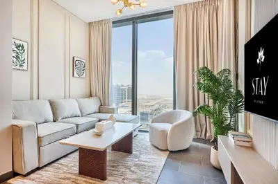 a living room with a couch and a large window at STAY BY LATINEM Luxury 1BR Holiday Home CB 1210 Near Burj Khalifa in Dubai