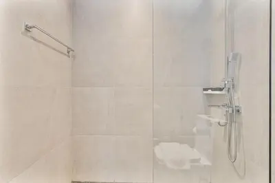 a bathroom with a shower with a glass door at Elegant Studio in Business Bay near Burj Khalifa in Dubai