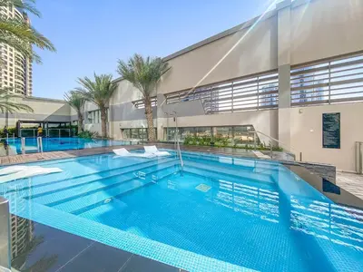 a large swimming pool in front of a building at Elegant Studio in Business Bay near Burj Khalifa in Dubai