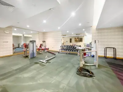 a gym with several treadmills and machines in a room at Elegant Studio in Business Bay near Burj Khalifa in Dubai