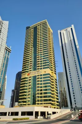 a tall building in the middle of a city at Chic Waterfront Location with Direct Metro Access and a Glimpse of Ain Dubai, Lake City Tower, Jumeirah Lake Towers by Deluxe Holiday Homes in Dubai