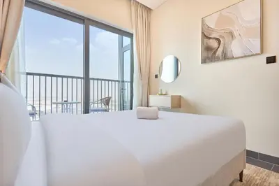 a bedroom with a large white bed and a large window at STAY BY LATINEM Luxury 1BR Holiday Home CB 1807 Near Downtown in Dubai