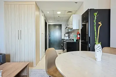 a kitchen and dining room with a table and chairs at Luxury Studio Near Downtown Dubai in Dubai
