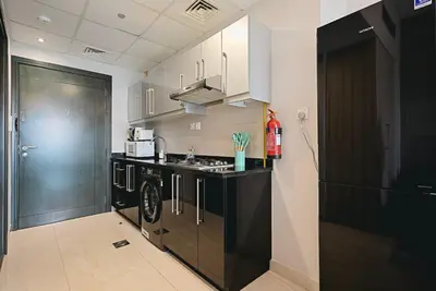 a kitchen with a sink and a stove at Luxury Studio Near Downtown Dubai in Dubai