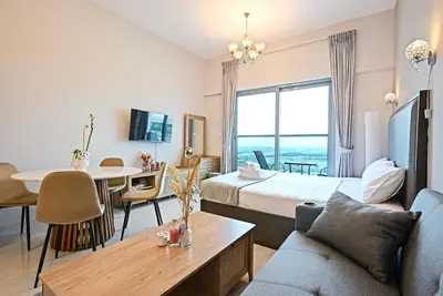 a hotel room with a bed and a dining room at Luxury Studio Near Downtown Dubai in Dubai