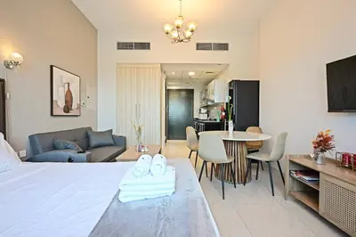 a bedroom with a bed and a living room at Luxury Studio Near Downtown Dubai in Dubai