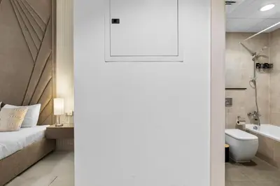 a bathroom with a bed and a toilet and a sink at BirdsEye Cozy Studio Mesmerizing Golf Views in Dubai