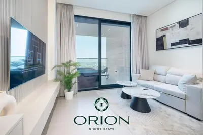 a living room with a couch and a table at Stunning Luxury Studio with Jacuzzi and Canal View on High Floor, Close to Dubai Mall, Swimming Pool, Advanced Gym with PT, Sauna, Steam Room, Ice Bath, Swimming Pool, Best Building in Area in Dubai