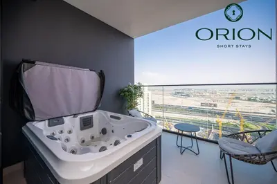 a bathroom with a tub and a chair and a window at Stunning Luxury Studio with Jacuzzi and Canal View on High Floor, Close to Dubai Mall, Swimming Pool, Advanced Gym with PT, Sauna, Steam Room, Ice Bath, Swimming Pool, Best Building in Area in Dubai