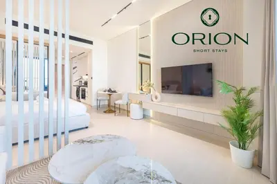 a hotel room with a bed and a tv at Stunning Luxury Studio with Jacuzzi and Canal View on High Floor, Close to Dubai Mall, Swimming Pool, Advanced Gym with PT, Sauna, Steam Room, Ice Bath, Swimming Pool, Best Building in Area in Dubai