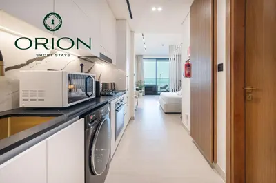 a kitchen with a microwave on a counter top at Stunning Luxury Studio with Jacuzzi and Canal View on High Floor, Close to Dubai Mall, Swimming Pool, Advanced Gym with PT, Sauna, Steam Room, Ice Bath, Swimming Pool, Best Building in Area in Dubai