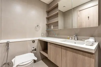 a bathroom with a sink and a toilet and a mirror at Panoramic High-Floor 1BR Overlooking Yachts and Dubai Water Canal, Moments from JBR Beach, LIV MarinaMarine Transport, and Skydive Dubai, LIV Marina, Dubai Marina by Deluxe Holiday Homes in Dubai