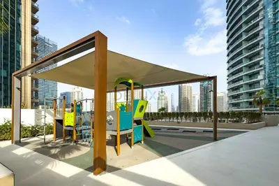 a playground with a canopy in a city at Panoramic High-Floor 1BR Overlooking Yachts and Dubai Water Canal, Moments from JBR Beach, LIV MarinaMarine Transport, and Skydive Dubai, LIV Marina, Dubai Marina by Deluxe Holiday Homes in Dubai