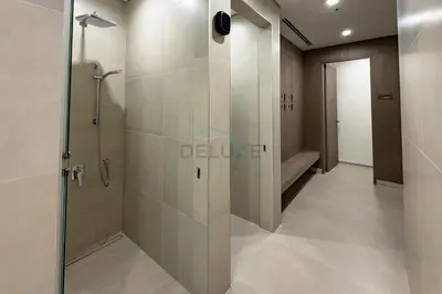 a bathroom with a shower with a glass door at Panoramic High-Floor 1BR Overlooking Yachts and Dubai Water Canal, Moments from JBR Beach, LIV MarinaMarine Transport, and Skydive Dubai, LIV Marina, Dubai Marina by Deluxe Holiday Homes in Dubai