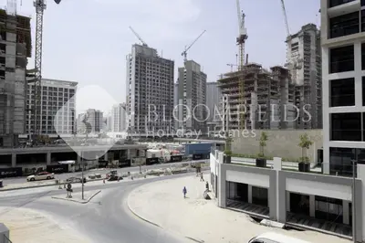 a view of a street in a city with tall buildings at Bloomfeilds Comfortable STU Azizi Rivera in Dubai
