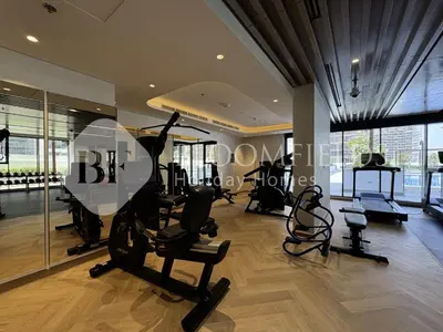 a gym with treadmills and exercise equipment in a building at Bloomfeilds Comfortable STU Azizi Rivera in Dubai