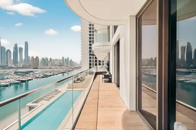 a balcony with a view of a river and buildings at Luxury 2BR Retreat Gorgeous Beach & Skyline Views in Dubai