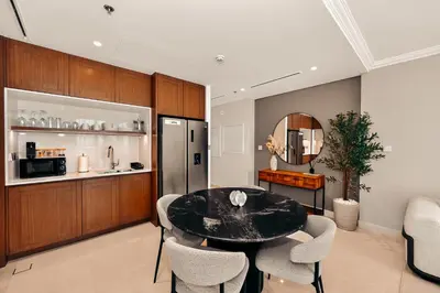 a kitchen and dining room with a table and chairs at Luxury 2BR Retreat Gorgeous Beach & Skyline Views in Dubai