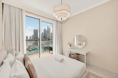 a white bedroom with a view of the city at Luxury 2BR Retreat Gorgeous Beach & Skyline Views in Dubai