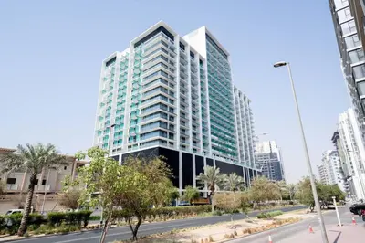 a tall building in the middle of a city at Serene Palette 1BR in Binghatti Azure with Gym & Pool in Dubai