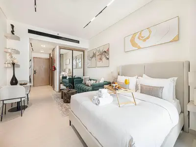 a bedroom with a large bed and a living room at Livin' Holidays - Studio - Bay View with Jacuzzi in Dubai
