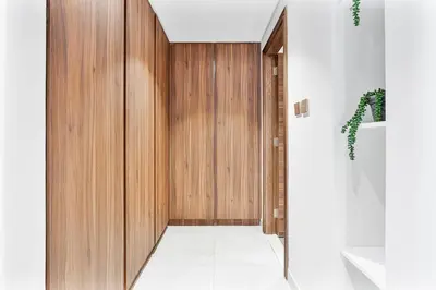 a hallway with a wooden door in a house at Radiant - 3BR - JVC - near Sports City & Autodrome in Dubai