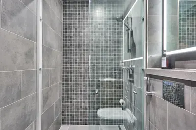 a bathroom with a shower with a toilet and a sink at STAY BY LATINEM Luxury 1BR Holiday Home CB 0919 Near Burj Khalifa in Dubai