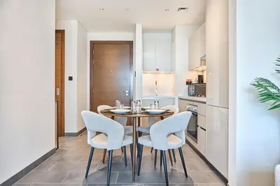 a kitchen and dining room with a table and chairs at STAY BY LATINEM Luxury 1BR Holiday Home CB 0919 Near Burj Khalifa in Dubai
